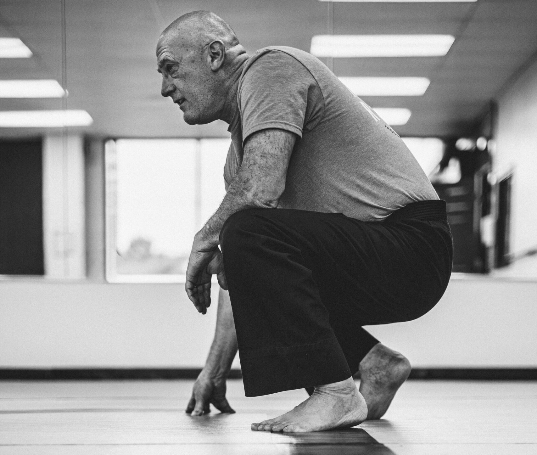 AR TKD adult student crouching in the training room
