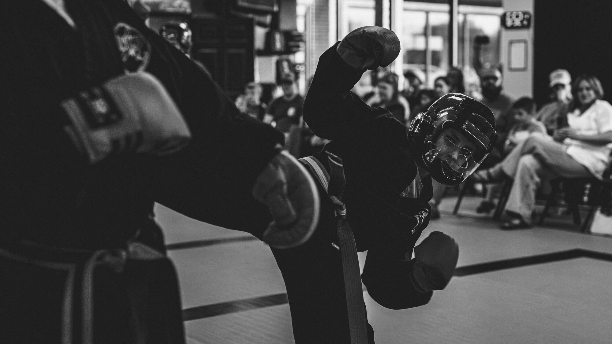 AR TKD tournament team sparring while teammates watch